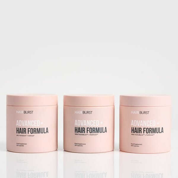 Three jars of Hairburst Advanced Hair Formula on a white background