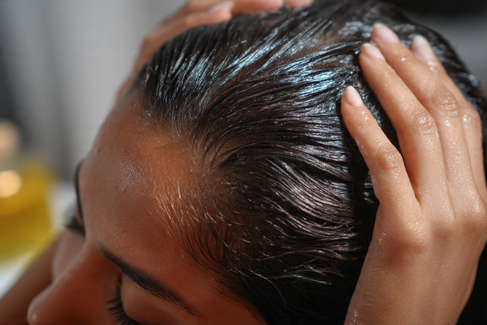 woman oiling scalp